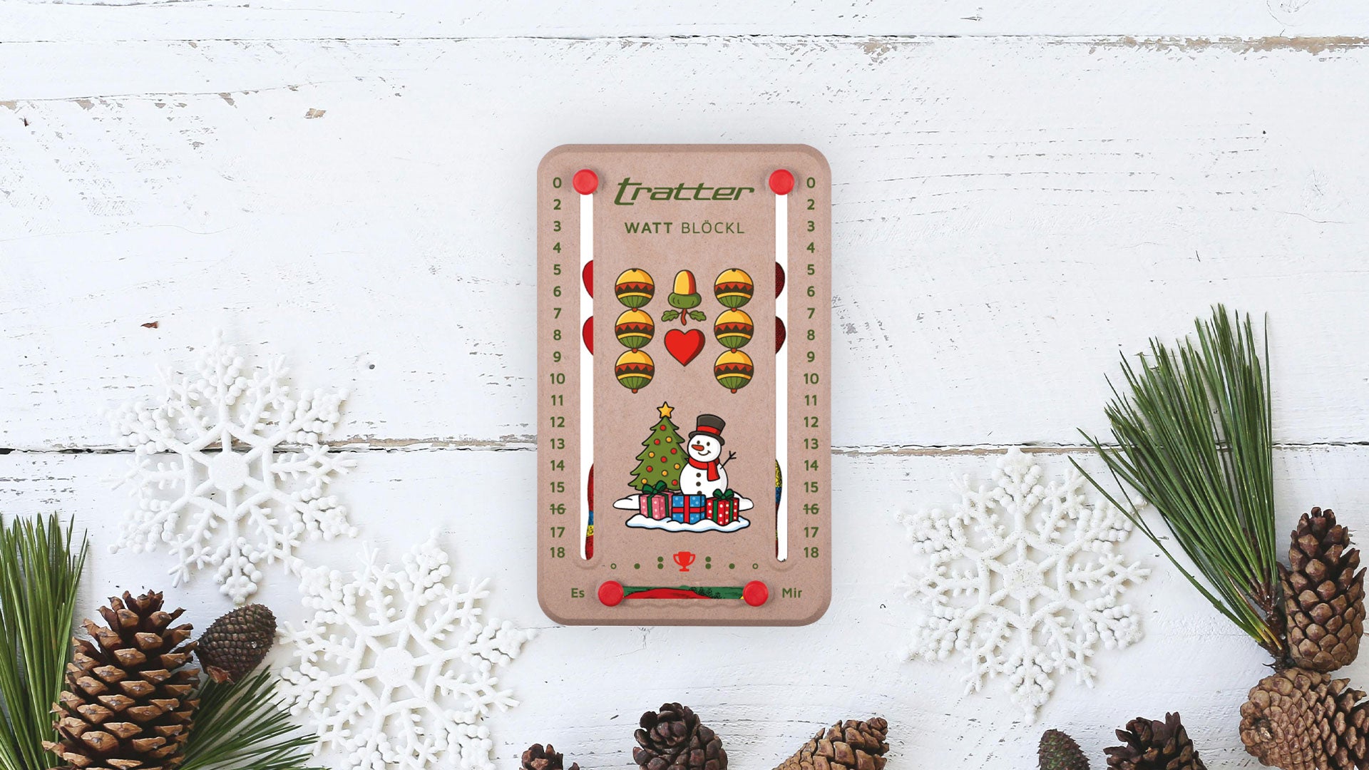 Wattblöckl mit Unternehmenslogo und Weinachts Layout auf weißem Holz mit Pinien Verzierungen im Hintergrund